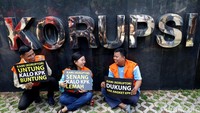 Tampak ada tulisan PANSUS di bagian dada kemejanya. Dia lalu disambut 3 orang yang menggunakan baju tahanan yang berperan sebagai napi Lapas Sukamiskin.
