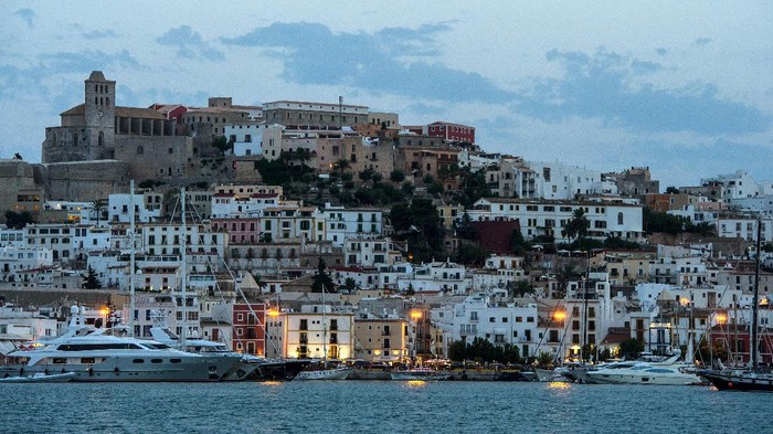 IBIZA, SPAIN - AUGUST 22:  A general view of Ibiza old town at dusk on August 22, 2013 in Ibiza, Spain. The small island of Ibiza lies within the Balearics islands, off the coast of Spain. It has, for many years, had a reputation as a party destination. Each year thousands of young people gather to enjoy not only the hot weather and the beaches but also the array of clubs with international DJs playing to vast audiences. Ibiza has also gained a reputation for drugs and concerns are now growing that the taking and trafficking of drugs is spiralling out of control.  (Photo by David Ramos/Getty Images)