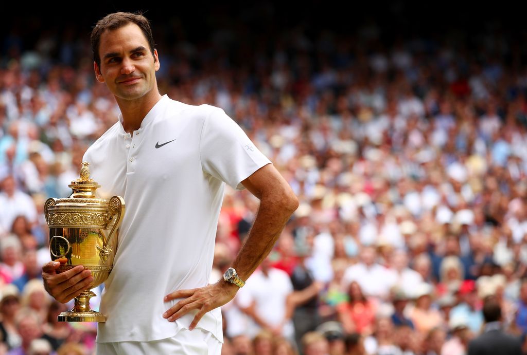 Roger Federer LONDON, ENGLAND - JULY 16: Roger Federer of Switzerland celebrates victory with the trophy after the Gentlemen's Singles final against Marin Cilic of Croatia on day thirteen of the Wimbledon Lawn Tennis Championships at the All England Lawn Tennis and Croquet Club at Wimbledon on July 16, 2017 in London, England. (Photo by Clive Brunskill/Getty Images)