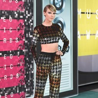 Taylor Swift memakai pump d’Orsay rancangan Christian Louboutin dari seri Pumpstagram koleksi Fall 2015. Sepatu bergaya edgy ini dihiasi kulit emas yang mengilap pada bagian ujung kaki dan strap yang menyilang. Kesan feminin hadir pada aksen mesh pada bagian belakang sepatu. Foto: Getty Images