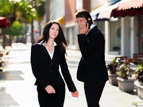 Young Businessman and Businesswoman Walking