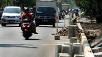 Pekerja tengah mengerjakan pemasangan konblok pembatas jalan, disepanjang jalan Danau Sunter Selatan, Jakarta Utara, Rabu (26/07/2017).