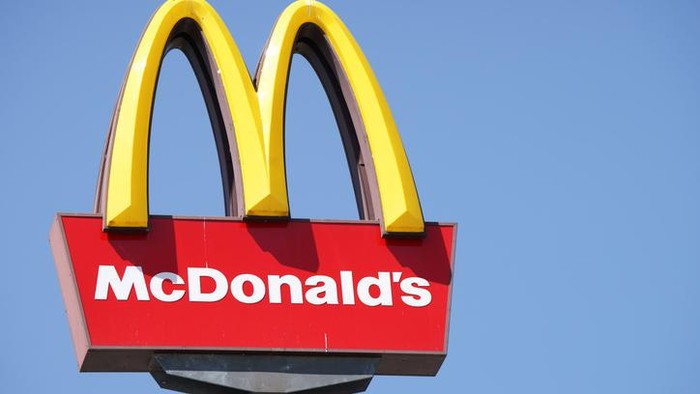 Ljubljana, Slovenia - September 3, 2011: Close-up of McDonalds outdoor sign with typical rounded yellow M letter against cloudless blue sky. Sign is positioned on the left side of image.
