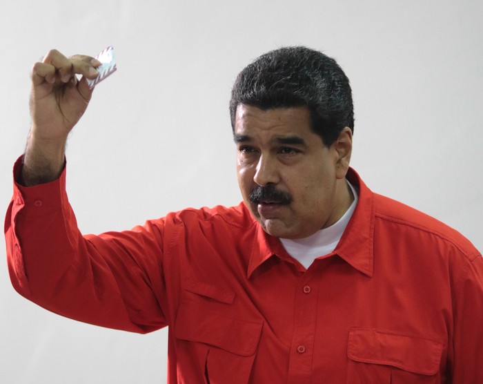 Venezuelan President Nicolas Maduro show his ballot as casts his vote at a polling station during the Constituent Assembly election in Caracas, Venezuela July 30, 2017. Miraflores Palace/Handout via REUTERS ATTENTION EDITORS - THIS PICTURE WAS PROVIDED BY A THIRD PARTY.     TPX IMAGES OF THE DAY