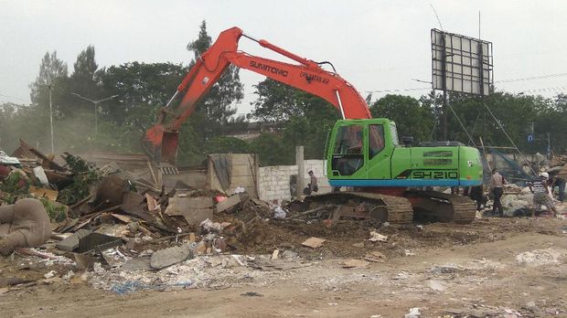 Alat-alat berat masih merapikan puing-puing bangunan.