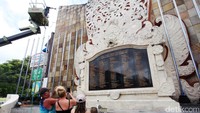 Beberapa wisatawan mengabadikan monumen yang sedang dibersihkan.