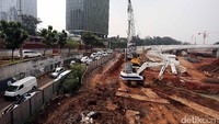 Lokasi proyek pembangunan Tol Desari ditutupi dengan seng. Sementara arus lalu lintas di sekitar lokasi tampak ramai.