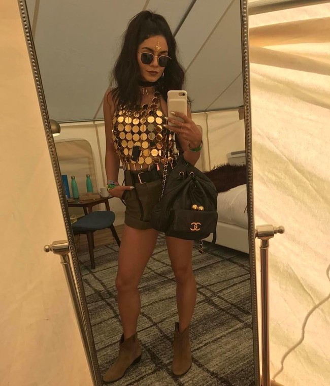 Vanessa Hudgens membuat statement dengan atasan metalik dan memadukannya bersama celana pendek dan boots yang lebih simpel.