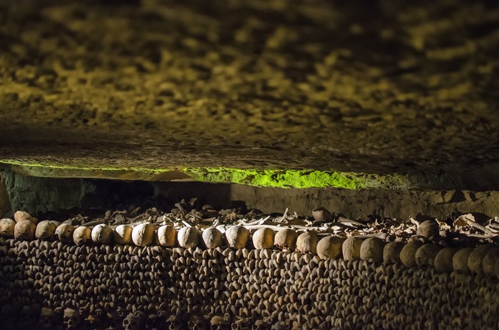 The Realm of the Dead, the Catacombs of Paris or Catacombes de Paris are underground ossuaries in Paris, France. Halls and caverns of walls of carefully arranged bones and skulls of over 6 million people.