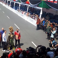 Sedikit terlihat ikon 3 garis hitam di sneakers putih Jokowi menandakan sepatunya bermerek adidas kali ini.