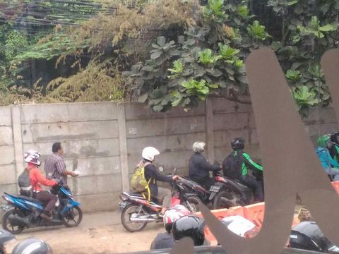 Pemotor yang tak sabar melintas di trotoar