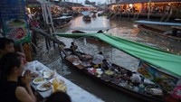 Pengunjung bisa menyantapnya di warung pinggir sungai maupun di atas perahu. Foto: AFP