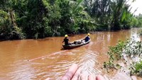 Pekerja PLN mengangkut tiang listrik melewati Sungai Perak menuju Pulau Kijang yang berada di Kecamatan Reteh, Kabupaten Indragili Hilir, Riau. Perjalanan menyusuri Sungai Perak menuju lokasi memakan waktu antara 4-5 jam. Dok. PLN Wil. Riau dan Kepulauan Riau.