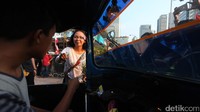 Seorang pengendara menerima bunga yang diberikan.