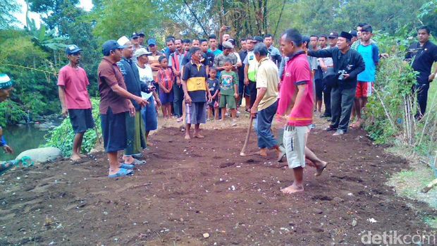 Warga meratakan tanah yang menyerupai makam