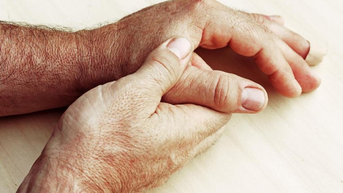 An elderly man has pain in fingers and hands