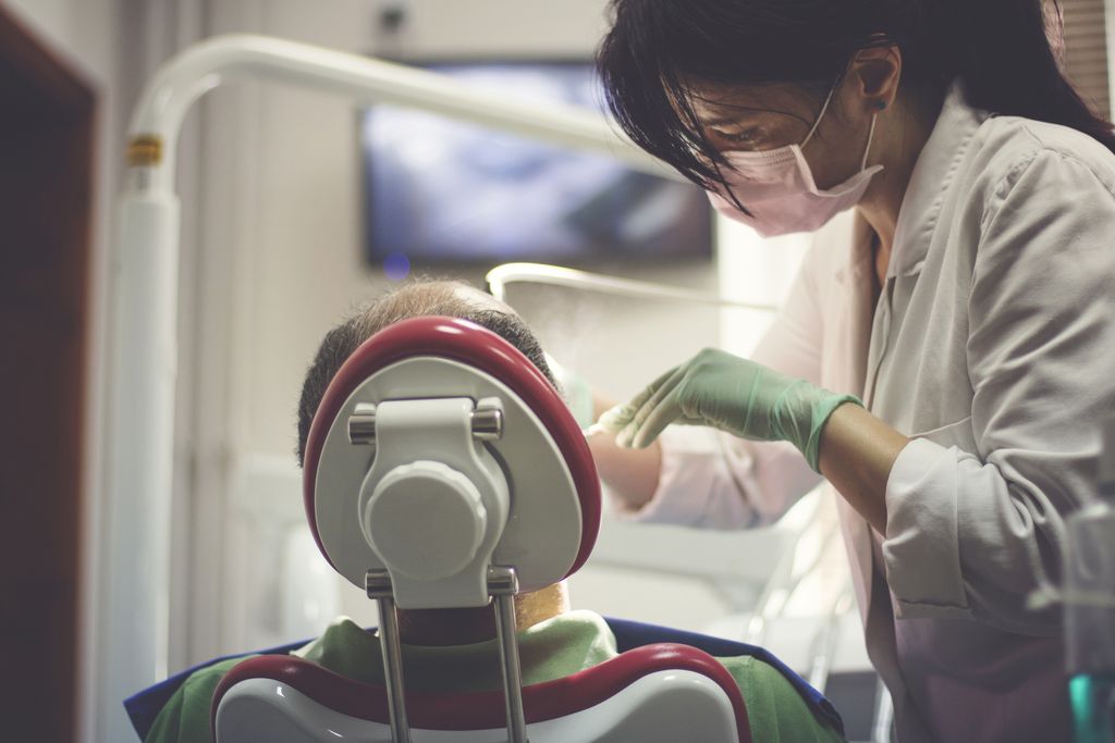 Dentist examines the teeth of patient