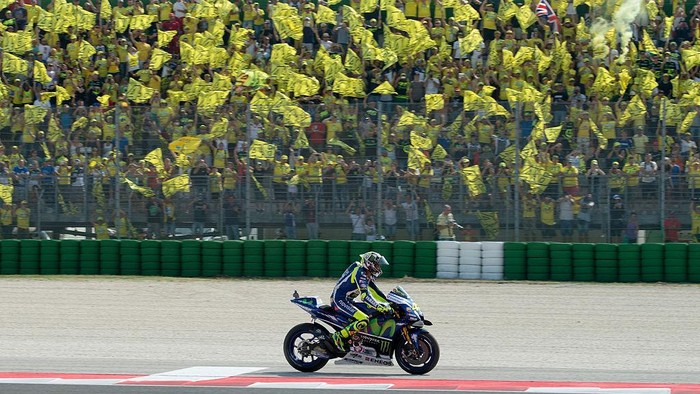 MISANO ADRIATICO, ITALY - SEPTEMBER 11:  Valentino Rossi of Movistar Yamaha MotoGP team celebrates with fans after the MotoGP of San Marino race at Misano World Circuit on September 11, 2016 in Misano Adriatico, Italy.  (Photo by Mirco Lazzari gp/Getty Images)