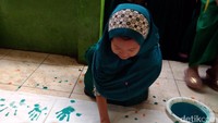 Seorang siswi menempelkan telapak tangannya.