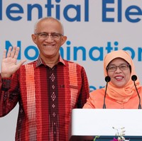 Riasan wajah Halimah Yacob pun tampak sederhana. Ia hanya memulaskan lipstik merah untuk membuat wajahnya terlihat lebih segar. Foto: REUTERS/Edgar Su
