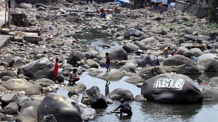 Sejumlah warga berkativitas di Sungai Ciliwung yang mengering di Kota Bogor, Jawa Barat, Selasa (12/9).  Debit Sungai Ciliwung mengalami penurunan drastis, surutnya sungai  diakibatkan oleh musim kemarau. ANTARAFOTO/Yulius Satria Wijaya/pd/17.