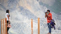 Sepasang traveler yang asyik berfoto. Yang satu mengabadikan, yang satu berpose depan kamera (Wisma/detikTravel)