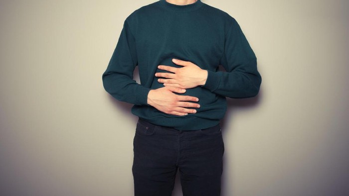 kenyang A young man is rubbing his stomach
