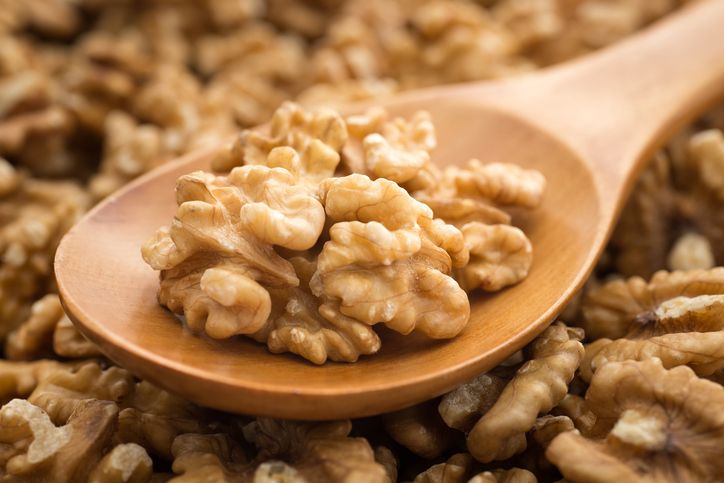 walnut Walnuts with wooden spoon on background