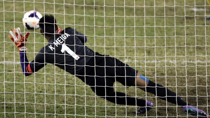 NAY PYI TAW, BURMA - DECEMBER 19: Kurnia Meiga of Indonesia saves in the penalty shoot out after extra time during the Mens Semi Final Match between Malaysia and Indonesia during the 2013 SEA Games at Zeyar Thiri Stadium on December 19, 2013 in Nay Pyi Taw, Burma.  (Photo by Stanley Chou/Getty Images)