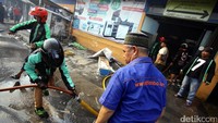 Driver ojek online berjibaku untuk memadamkan kebakaran.