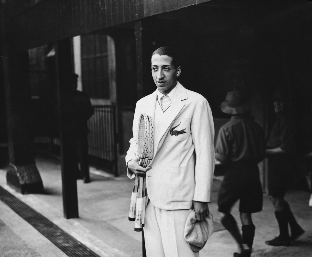 French Tennis player Rene Lacoste, one of France's 'Four Musketeers' who won the Davis Cup in 1932, at Wimbledon. He is wearing his embroidered crocodile motif.  Original Publication: People Disc - HH0434   (Photo by Topical Press Agency/Getty Images)