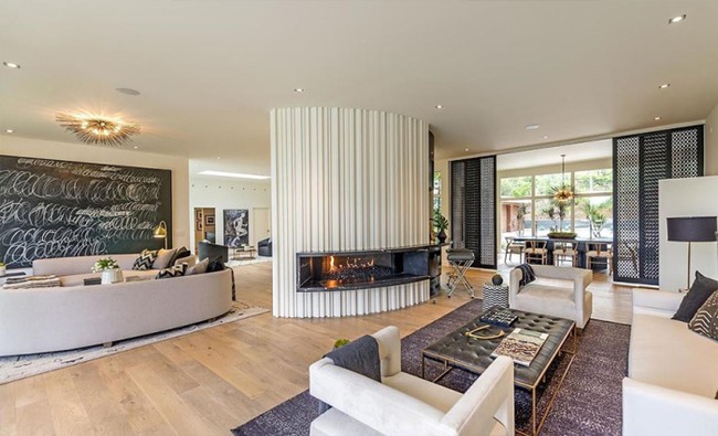 Ruang tamu dibuat menyatu dengan ruang keluarga untuk memberikan kesan luas dan nyaman. Nuansa modern sangat terasa di rumah berlantai kayu ini berkat pemilihan furnitur warna putih abu-abu. Foto: Dok. Partners Trust