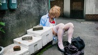 Fotografer Inggris, Lee Chapman, mendokumentasikan sisi lain dari warga Jepang. Ia memotret orang mabuk yang tak sadarkan diri di area publik. Seperti wanita di samping deretan kotak ini. Foto: Lee Chapman