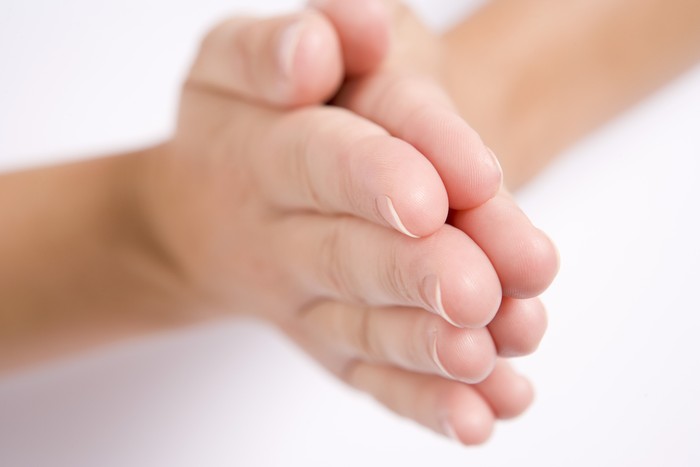 Womans hands together in prayer