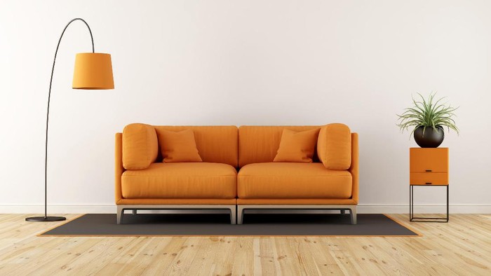 Modern living room with white wall, orange couch and floor lamp - 3d rendering