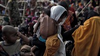 Seorang ibu menggendong anaknya yang sakit di kamp pengungsian di Coxs Bazar (REUTERS/Cathal McNaughton)