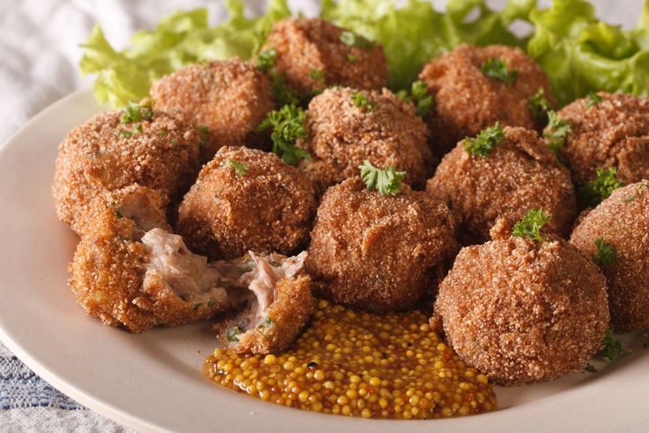 Dutch meat balls with mustard Bitterballen close-up on a plate on the table. horizontal