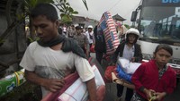 Pengungsi Gunung Agung asal Desa Muncan membawa barangnya saat mereka diantarkan ke kampungnya dari tempat penampungan sementara di Klungkung, Bali, Sabtu (7/10). ANTARA FOTO/Nyoman Budhiana.
