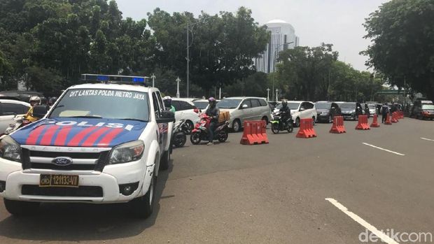 Jalan ditutup menggunakan road barrier dan traffic cone