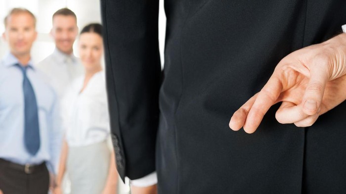 Business man carrying white mask to his body indicating Business fraud and faking business partnership