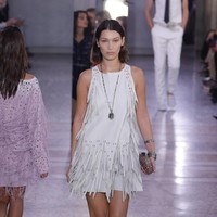 Bella Hadid dalam balutan dress putih beraksen fringe di fashion show Bottega Veneta.