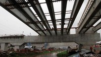 Para pekerja merampungkan pembangunan tol.