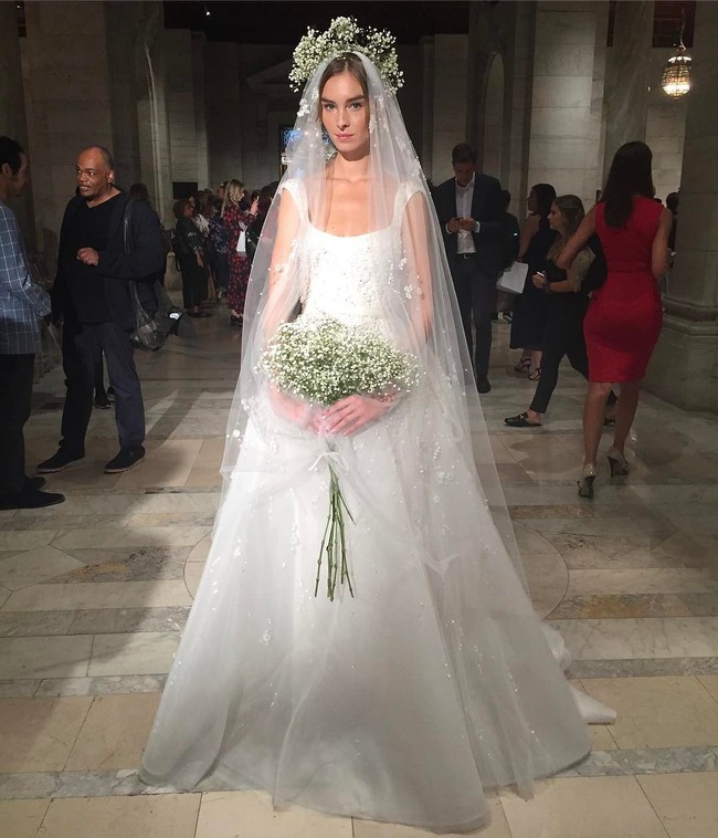 Reem Acra menawarkan gaun pengantin dengan potongan klasik. Tambahkan veil dengan bordir atau aplikasi bunga agar lebih spesial. (Foto: Instagram)