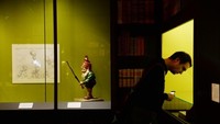 Seorang pengunjung sedang melihat-lihat koleksi pameran. Foto: Reuters/ AFP