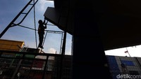 Pekerja mengerjakan penyelesaian akhir pembangunan gerbang tol Becakayu, Sabtu (21/10/2017).