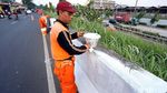 Biar Kinclong, Pasukan Oranye Cat Ulang Trotoar Jalan