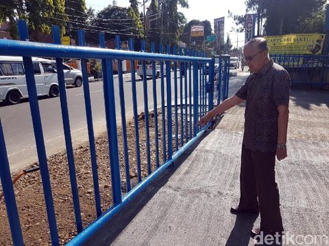 Pemilik Toko di Jalan Renata, Leo memperlihatkan halamannya yang sudah ditinggikan sama dengan tinggi trotoar