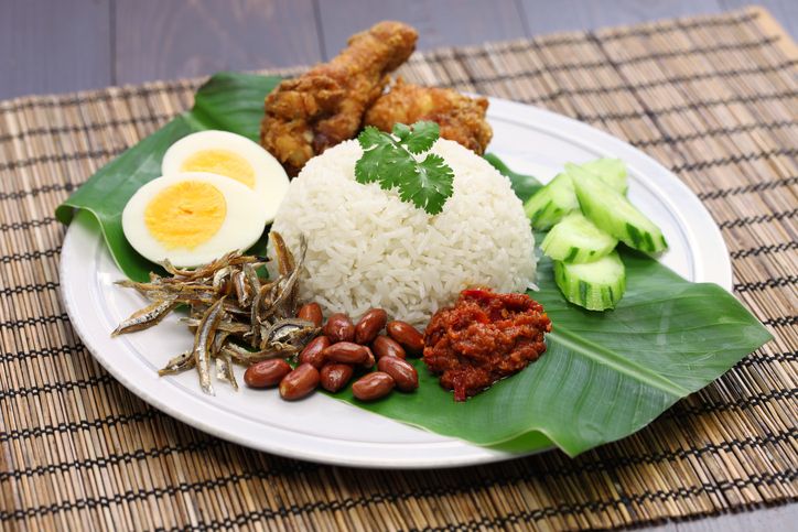 Nasi Lemak or 'creamy rice' is a Malaysian national dish. It contains rice cooked with coconut cream and pandan (screwpine) leaves, fried anchovies, fried peanuts, fried chicken, sambal (chili-based sauce that contains shrimp paste), boiled eggs and slices of cucumbers. Because of its versatility in being able to be served in a variety of manners, it is now served and eaten any time of the day. The dish is also popular in Singapore and Indonesia.