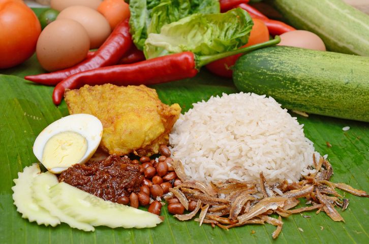 Nasi Lemak or 'creamy rice' is a Malaysian national dish. It contains rice cooked with coconut cream and pandan (screwpine) leaves, fried anchovies, fried peanuts, fried chicken, sambal (chili-based sauce that contains shrimp paste), boiled eggs and slices of cucumbers. Because of its versatility in being able to be served in a variety of manners, it is now served and eaten any time of the day. The dish is also popular in Singapore and Indonesia.