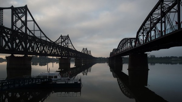 Sungai Yalu di utara memiliki jembatan persahabatan di utara Korut. Jembatan ini menghubungkan antara Korut dan China. (NICOLAS ASFOURI/AFP)